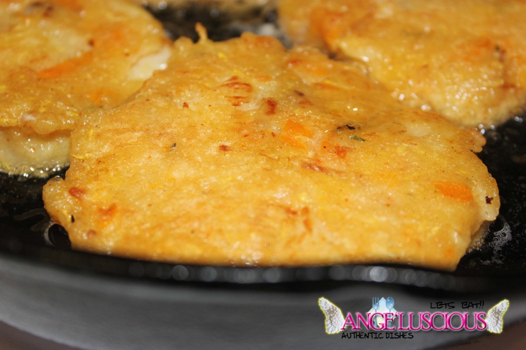 Salted fish fritters frying in cast iron skillet